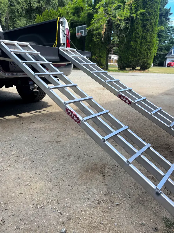 Custom aluminum loading ramps on a pickup truck