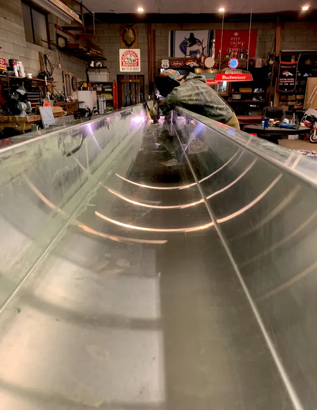 Long stainless steel trough being fabricated in the shop